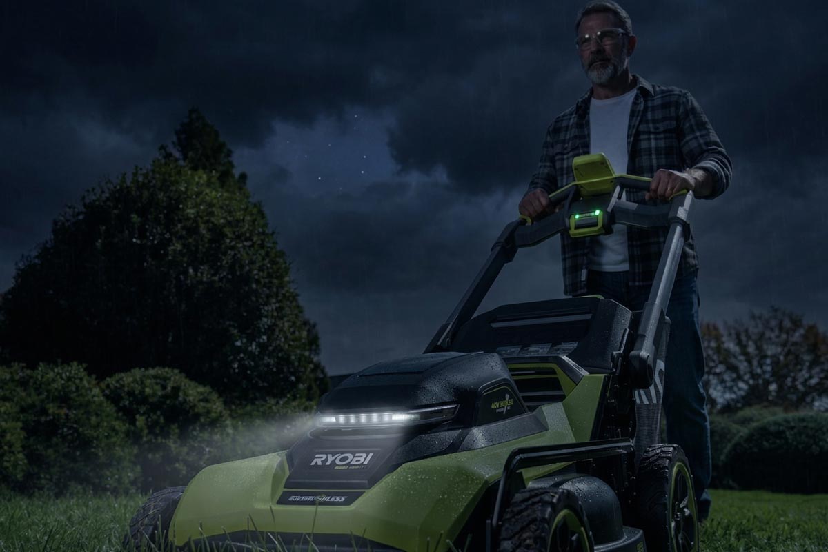 man pushing a greenworks lawnmower outdoors